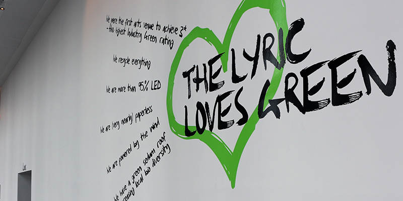 A wall decal at the Lyric Hammersmith shows a green heart, overlayed with the text "The Lyric loves green".